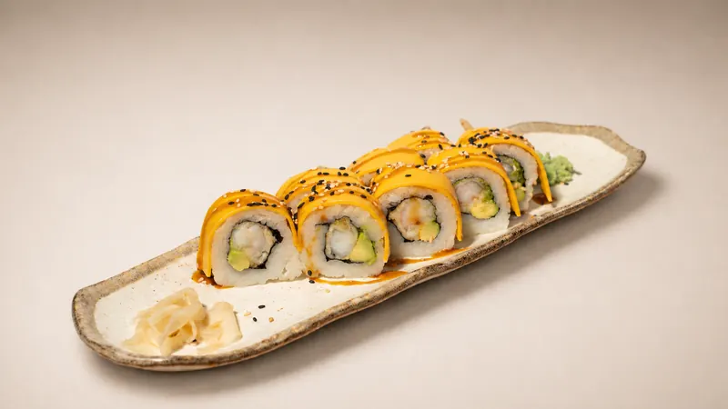 Cheddar Roll — Fried ebi prawn, avocado, seared cheddar slices, eel sauce, sesame, seaweed, rice
