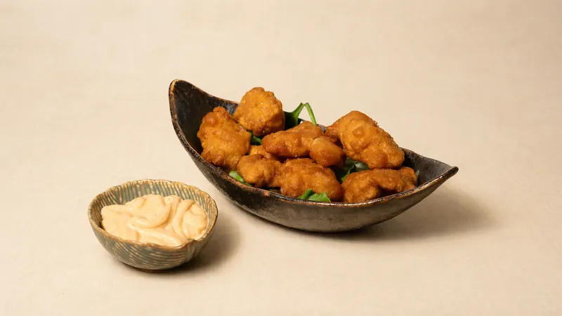Chicken Karaage — Fried chicken bites marinated in ginger and garlic, served with jalapeno sauce and sesame