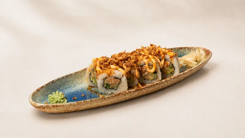 Spicy Salmon Crunch — Fried salmon, avocado, eel sauce, spicy mayo, crunchy onion, seaweed, rice