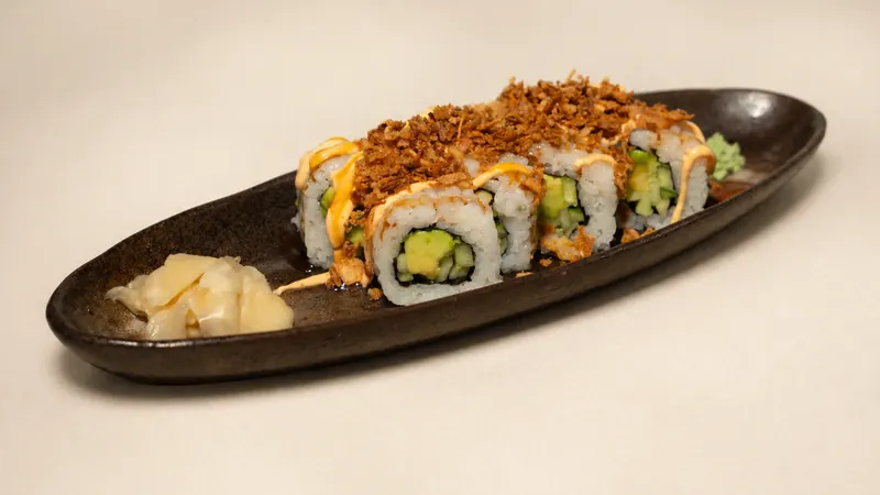 Veggie Crunch Roll — Cucumber, avocado, eel sauce, spicy mayo, crunchy onion, seaweed, rice