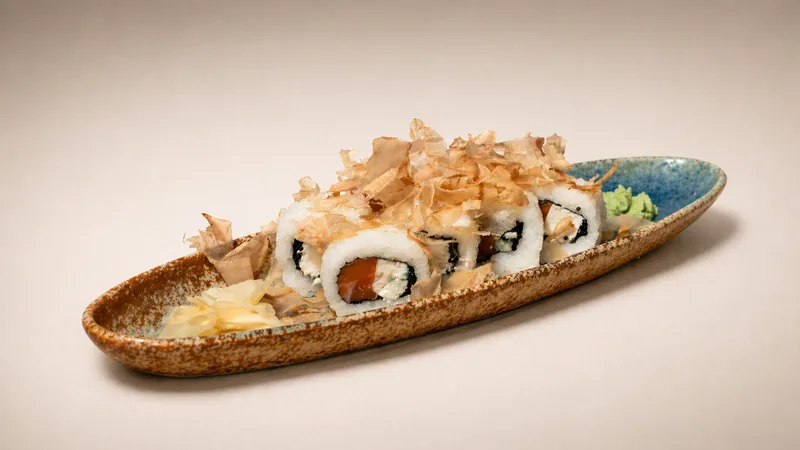 Yakudza roll — Black tobiko, salmon, feta, bonito, onion, seaweed, rice